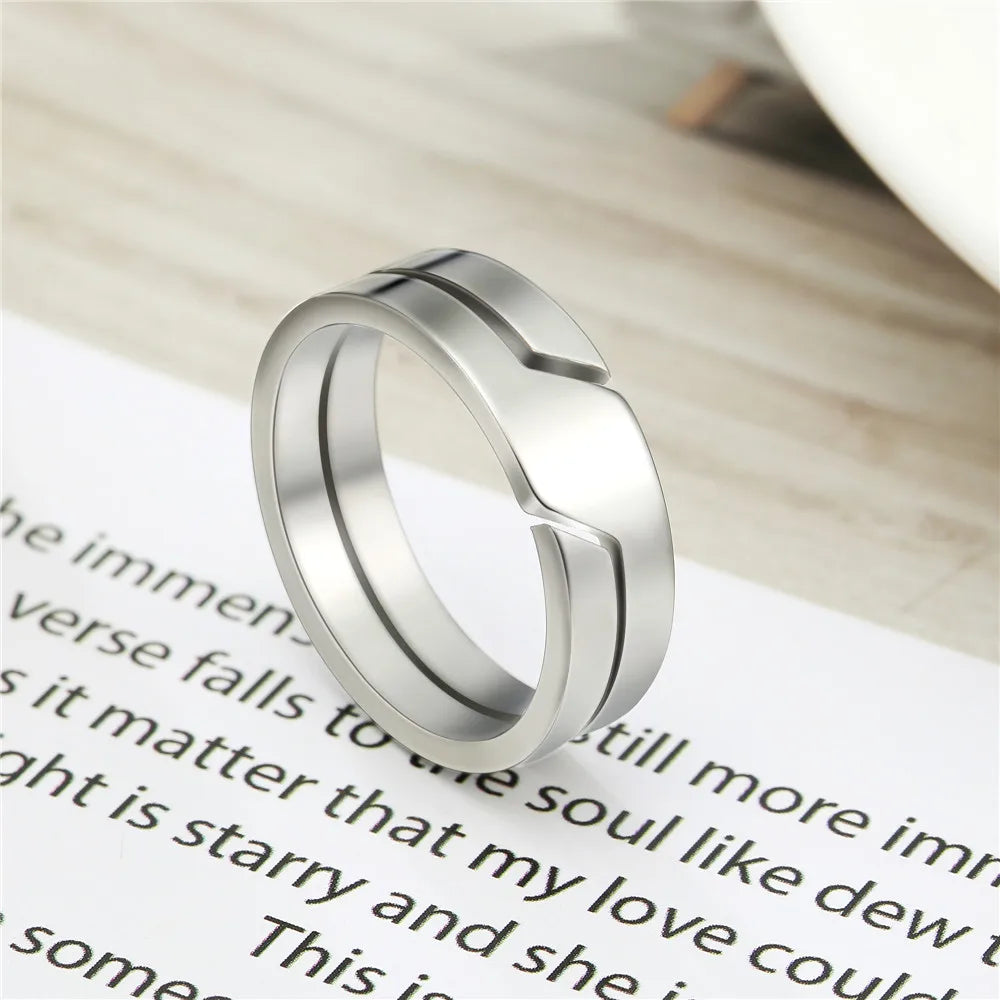 Close-up of Skyrim couple rings, stainless steel material with polished finish, showing geometric details.